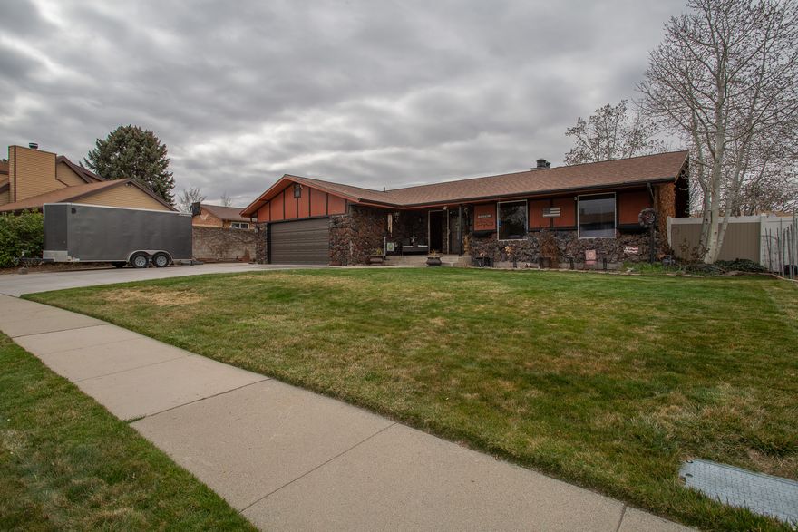 Wow! What a great home! Beautiful kitchen with large granite bar counter top. Dining room also. Family room with fireplace for getting cozy on the cold nights. Nice laminate flooring. 3 well apportioned bedrooms and 1.5 bath on the main floor.  In the basement you will find another bedroom (or craft room, if you prefer) and a big family room (theater room, if you prefer). Fully fenced yard with huge RV parking area. Storage shed included. New roof in 2024. New garage door and opener 2025. Love this home!