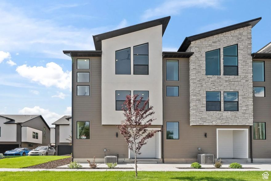 You'll fall in love with this stunning townhome located in the highly sought-after Fort Union neighborhood of Midvale-just minutes from downtown Salt Lake City. Surrounded by charming local restaurants, cozy coffee shops, vibrant shopping, entertainment, and scenic parks, this community truly offers something for everyone.  This beautifully designed home features 2 spacious bedrooms, each with its own private en-suite bathroom, including a soaker tub in the primary suite for ultimate relaxation. With 2.5 bathrooms total and a finished 2-car garage complete with insulated doors, convenience and comfort are built in.  Step inside to discover high-end finishes throughout, including:  Stunning expansive 12-foot island offering abundant seating and a central gathering space. Beautiful quartz countertops with a designer farmhouse sink. Upgraded cabinetry with soft-close doors and drawers. Signature Series stainless steel appliances, including a gas range. Elegant designer tile work in the bathrooms. Sleek Euro glass shower doors for a modern touch. No need to worry about window treatments; new blinds are included. Features a sleek modern fireplace that adds warmth and sophistication to the living space. Whether you're entertaining guests or enjoying a quiet evening at home, this townhome offers the perfect blend of luxury, location, a view of our majestic mountains and lifestyle. The first level is the garage