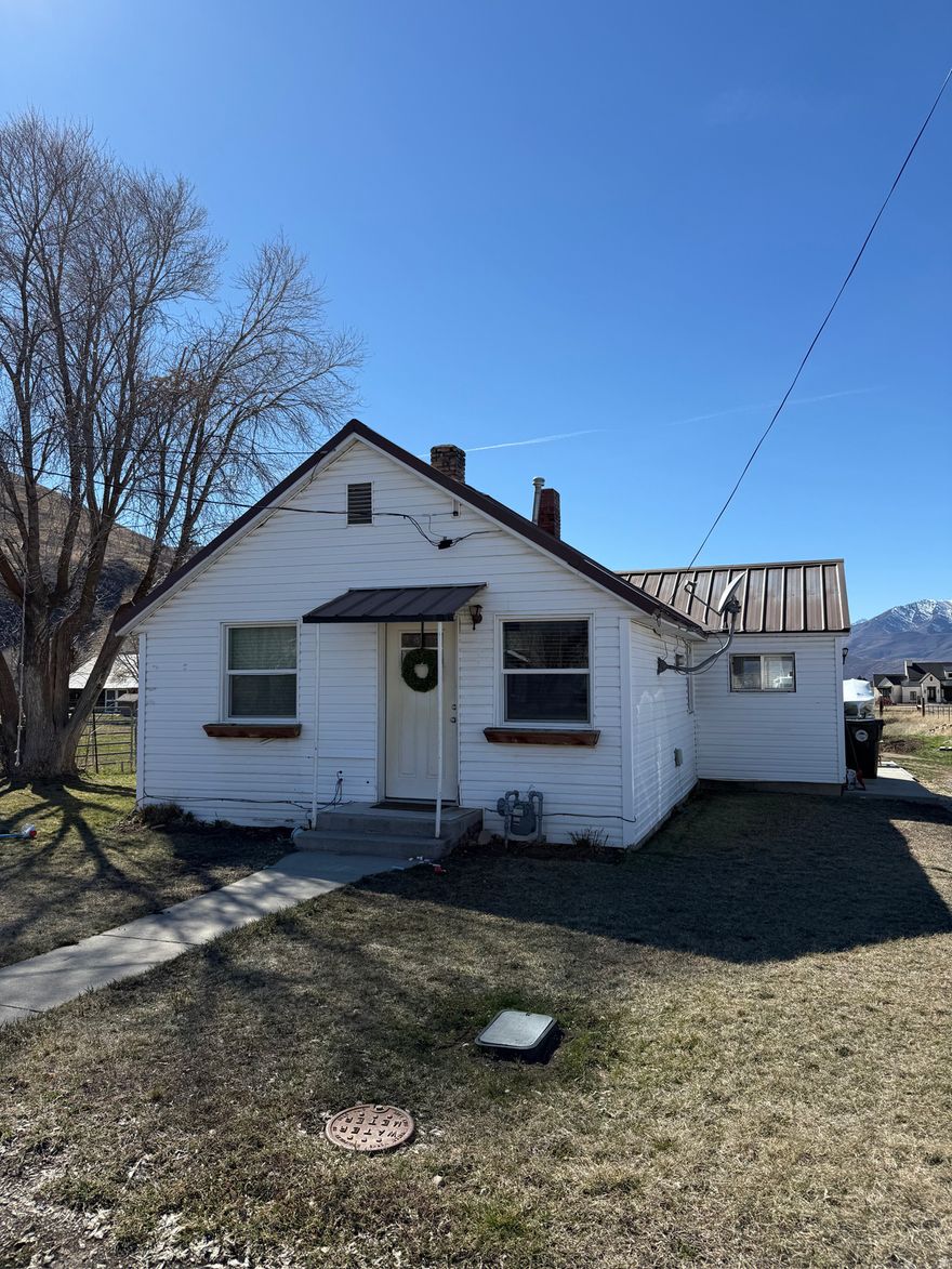 Enjoy the peace and quiet of country living with this charming 2-bedroom, 1-bath home located on .38 acres in scenic Heber City. Set in a calm and spacious area, this property offers a rare opportunity to enjoy open space, mountain surroundings, and a slower pace of life while still being just minutes from town amenities.  Located at 3224 S Daniels Rd, the home features several recent upgrades, including a new furnace and a new water heater, providing comfort and peace of mind for the next owner. Also features a spacious shed behind the property for extra storage.  The property offers excellent potential for expansion, making it ideal for buyers who want to build onto the existing home or add additional living space in the future. One of the standout features of this property is the spacious back field, which provides an opportunity for extra storage or parking for equipment, trailers, boats, RVs, or other items. This creates the potential to generate additional monthly income by renting out storage space. It also provides the opportunity to keep animals fenced in on the property as well.   Whether you're looking for a starter home, investment opportunity, or a property with expansion and income potential, this home offers a unique chance to own in one of Utah's most desirable mountain communities.  All property information is deemed reliable but not guaranteed. Buyers are advised to conduct their own due diligence and verify all details including square footage, zoning, property use, and potential expansion opportunities.