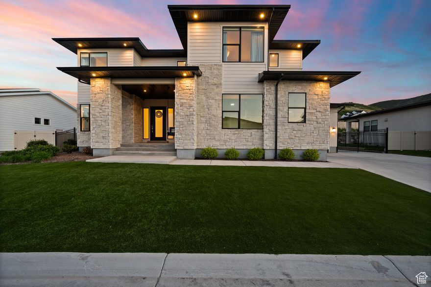 Inside the privacy of a well-maintained and gated community, thoughtful design and acute attention to detail are few of the many qualities that set his home apart. As you enter the main level, an entertainer's kitchen with ample storage, top tier appliances and an expansive island create a joyful environment to gather in. Custom cabinetry elevates the kitchen along with other thoughtful locations of the home and is further exemplified in the open and bright family room, home office and master closet. An island and en-suite washer and dryer bring class and convenience to the master suite, and the large primary bathroom's standalone soaking tub and beautifully tiled shower create a luxurious atmosphere. Upstairs three bedrooms, two full baths and an additional family and laundry room await, all with an abundance of natural light and high-end finishes. The basement adds more use and functionality with a home gym, large entertainment room, two more bedrooms with private bathrooms, a wet bar, laundry hook-ups and more. A robust whole-house water filtration system, interior and exterior surround sound, heated deck and Control4 Home Automation to streamline sound, lighting, and security take the space even further. The fully landscaped and low maintenance yard with a custom waterfall, putting green, fire pit, Bullfrog Spa and consistently beautiful turf lawn make the outside spaces equally as pleasing as the home's interior.  All of these features and many others come together to create a space to be experienced. All furniture is also available for purchase.