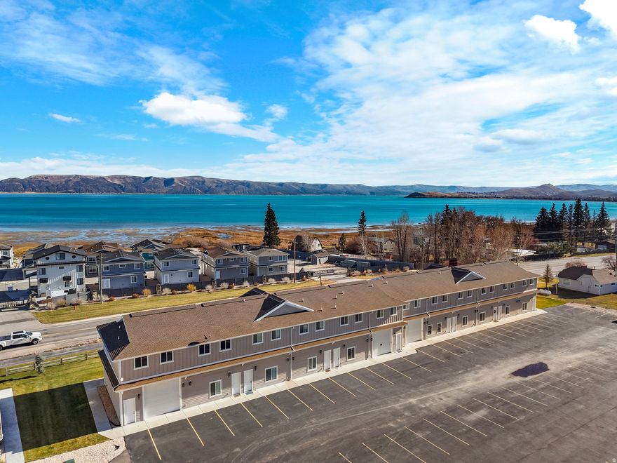 EASY BREEZY COASTAL LIVING! Fully furnished, turn-key townhouse just steps from the BEACH! Enjoy resort-style amenities including TWO POOLS, pickleball, splash pad, fitness room, and PRIVATE BEACH access! Walk to parks, eateries, and the shoreline of beautiful Bear Lake! Boat and overflow parking. NIGHTLY RENTALS ALLOWED through the HOA's on-site management company, ensuring consistent high-quality.  Ideal as a vacation home or investment property.