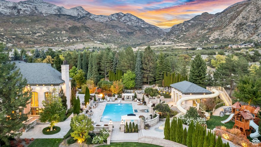 Welcome to Alpine Grove Estate, a rare masterpiece where timeless elegance meets modern luxury. Set on 9.24 pristine acres in the heart of Alpine, this private gated retreat features a 30,912 sq ft residence of extraordinary design. Arrive through the gates along a crushed pebble drive, cross a cobblestone bridge over Dry Creek and a serene pond, and be greeted by manicured gardens, mature trees, and mountain backdrops. The estate evokes the grandeur of a French chteau in Versailles, yet offers every amenity for today's lifestyle. Inside, soaring ceilings, hand-crafted details, and grand entertaining spaces create an atmosphere of sophistication and comfort. The home includes 8 bedrooms and 16 bathrooms, highlighted by a luxury private suite with spa, sauna, massage room, and steam shower-designed as a true sanctuary. Multiple gathering areas, a formal dining room, private in-home theater, fully outfitted gym, and more provide endless opportunities for living and entertaining. The grounds are equally impressive, designed for both recreation and retreat. A resort-caliber pool and spa feature a waterslide, splash pad, and pool house with its own kitchen-perfect for hosting guests. Meandering trails weave through gardens and outdoor living areas, while a rooftop deck reveals panoramic views of the surrounding mountains and Utah Valley. Additional amenities include a full mother-in-law suite, indoor basketball court, and an array of luxury finishes throughout, each thoughtfully curated to combine comfort, beauty, and function. Alpine Grove Estate is more than a home; it is a legacy property, offering unmatched privacy, luxury, and lifestyle in one of Utah's most sought-after settings. An additional ~3 acres with barn, tennis court, and guest house are also available for purchase. Buyer/Buyer's Agent to verify all info.