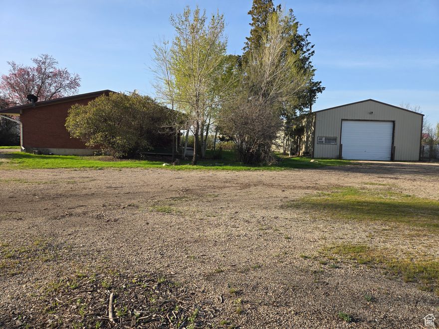 Excellent I-15 access. Next to a hotel, restaurant, and bank with nice vinyl fencing on 3 sides. A brick house, a metal shop, and a metal shed are currently on the property and all are functional. Please call Marriott-Slaterville city office for a current list of approved uses @ 801-627-1919. All buyers are advised to obtain independent measurements for square footage & lot size.
