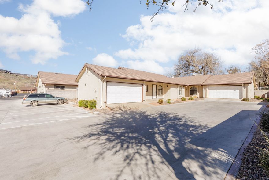 Great opportunity for a starter home or investment property in the heart of downtown St. George! Located in the Village Square Townhomes community, this 3-bedroom, 2-bath unit offers a comfortable and functional layout with a 2-car garage and a cozy fireplace in the living area. Enjoy unbeatable convenience with Utah Tech University, restaurants, shopping, parks, and entertainment just minutes away. This property offers excellent potential in a highly convenient location.