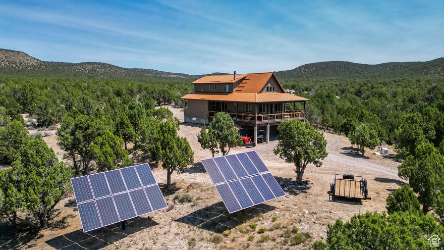 WELCOME HOME TO SOUTHERN UTAH! If you're dreaming of your own private slice of heaven, this extraordinary 40-acre furnished estate delivers. Nestled against both BLM and Forest Service land, it offers unrivaled off grid seclusion, panoramic mountain views, and a true sense of freedom-it's as if you own all of the mountains. Crafted with care and quality, the custom- built home features high-end finishes throughout and was designed to take full advantage of its breathtaking surroundings. Step out onto the expansive wraparound deck to soak in the scenery, or explore the impressive 3-car tandem garage with ADDITIONAL ATV pull-in storage beneath. Equestrian lovers and outdoor enthusiasts will be thrilled by the well maintained horse pasture(s), stalls, and round pen and direct access to endless trails for riding, hiking, and biking. From your backyard, you can hunt for mountain lions, deer, elk, and more-this is a true sportsman's paradise. Where sustainability meets luxury, this SOUTH FACING property boasts a fully owned, state-of-the-art solar power system with automatic controls to a whole home generator for peace of mind, a whole-home water filtering system, private spring-fed well for exceptionally pure water. Located just 8 miles from town and 5 miles from Enterprise Reservoir-ideal for kayaking, boating, and fishing-and only an hour from St. George or Cedar City. Zion National Park is a scenic 2-hour drive away, making this the perfect balance of seclusion and accessibility. Whether you're entertaining guests, building a homestead, or simply escaping the noise of city life, this one-of-a- kind mountain retreat offers the lifestyle you've been searching for. Buyer and Buyer's Agent to verify all information, including square footage and acreage, to their satisfaction. For the VIRTUAL TOUR.. VISIT HERE--https://my.matterport.com/show/?m=Bp1kRdDe3NL