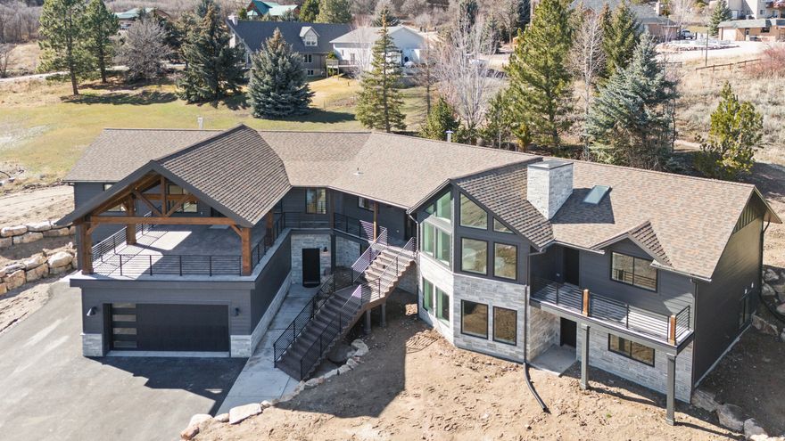 DO NOT LET THE YEAR BUILT FOOL YOU!!  This re-imagined Eden residence has undergone a complete transformation, featuring a thoughtful expansion and full renovation that delivers the look, feel, and quality of new construction without the extended build timeline. While originally built in 1994, nearly every interior space, finish, and major system has been replaced or upgraded, creating a home that lives entirely modern. Designed to embrace its elevated setting, the home is oriented to capture breathtaking views of Pineview Reservoir, with daily connections to water, mountains, and sky. Spanning 5,954 sq ft, the layout offers 5 bedrooms, 4 bathrooms, a fitness studio, office with exterior entrance, game room, and expansive living spaces ideal for both everyday living and entertaining. Set on 1 acre, highlights include an 861 sq ft view deck, extra-deep 5-car garage (1,700 sq ft) with EV charging, expansive primary suite with oversized walk-in shower and freestanding soaking tub, scullery/back kitchen, large mudroom with custom lockers, and dual laundry areas. The home features ICF construction, new roof, new high-end appliances, new Prella windows, updated wiring and plumbing, dual HVAC systems, and new exterior rock and siding. A rare opportunity to enjoy nearly new construction quality in an established Eden location with unparalleled views.