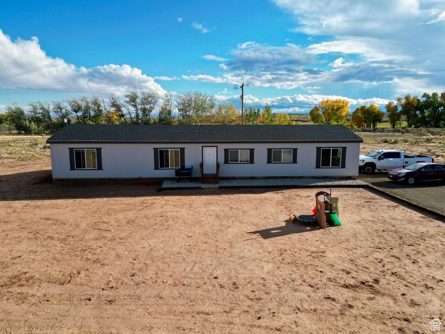 2024 home on 23 acres in Cedar View! Keep all 23 acres for yourself or split the land. The home features 4 bedrooms, 2 bathrooms, large pantry, and a mud room. The property has a commercial water connection providing plenty of water for a hobby farm. Outside features paved parking, a shipping container for storage, RV parking with a power outlet, and an RV dump. A well can be drilled on the property for outdoor use. Square footage is approximate. Buyer to verify all.