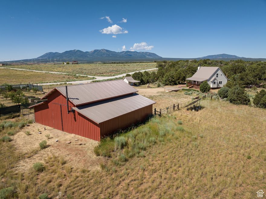 Nestled on 6 acres with breathtaking views of the La Sal Mountains, this property offers the perfect balance of nature and modern living. Enjoy the peaceful pinion-juniper forest on the back side of the property while the front provides ample space for farming, gardening, or keeping horses with RV Pad & Full Hookups - Perfect for RV Enthusiasts! The large 40x42', versatile barn can accommodate hobbies, storage, or even be converted into additional living space. The home features a main-level bedroom, a den/office that could serve as a small third bedroom, and a loft connecting to the spacious grand suite on the second floor. Recent updates include a new metal roof, siding, water heater, and modernized kitchen flooring, ensuring the home is in excellent move-in ready condition.   Outdoor enthusiasts will appreciate the fenced orchard with 38 fruit trees, garden beds, and irrigation spigots for efficient irrigation, as well as the horse-ready land with a gated fence. Solar panels enhance energy efficiency, while fiber internet ensures easy remote work. Just minutes from Monticello, enjoy convenient access to local shops, restaurants, and a charming library. The nearby Abajo Mountains provide year-round activities, including hiking, fishing, hunting, and winter sports. With proximity to state and national parks, this property offers a serene lifestyle and endless possibilities for growth and expansion. Whether you're looking to settle down in a peaceful environment, pursue farming, or have space for your horses, this home offers it all. Water shares: Deed states-an undivided 1/8 interest in a (Elk Meadows neighborhood) well and well equipment, plus state water rights. Square footage figures are provided as a courtesy estimate only.  Buyer is advised to obtain an independent measurement.
