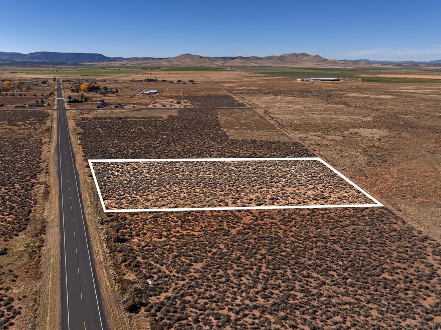 2.21 Acres in Enterprise with Water Right & Quiet Country Living!   Looking for space, freedom, and flexibility? This 2.21-acre parcel in Enterprise offers plenty of room for livestock, gardens, or your next home project in Southern Utah. With wide-open views and a peaceful rural setting, it's the ideal spot to create your own retreat away from the rush.   Zoned Ag-20 and located within Washington County, this property allows a range of permitted uses. The new buyer will apply for a septic permit through SW Utah Health. Natural gas lines run in front of the property. Communication lines are close by (if desired). Ask agent about sellers correspondence with the power department. Off grid living is also possible and a much desired opportunity in this area. Survey corners markers are in all corners and easy to find.    The sellers are including 1 acre-foot of water with right #71-5993 with a priority date of 1945. The water district is currently processing a change application to assign this right to the parcel-once approved, buyers will receive well-drilling cards and one can rock and roll right away to drill for a well. (Contact agents for updates on application status.)   This parcel offers both function and flexibility-ready for your ideas, animals, and future home.