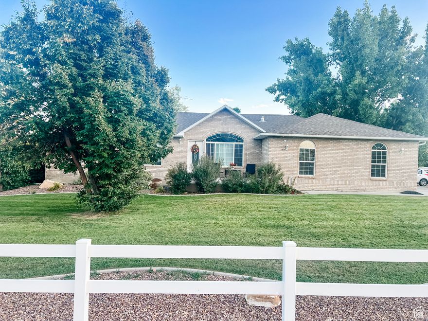 Welcome home to this beautiful 5 bedroom, 3 bath all-brick rambler, tucked away in the highly sought-after Maeser area.  From the moment you arrive, you'll notice the charm of its timeless exterior and the tranquility of the surroundings.  Set on a spacious half acre lot, this property feels like your own private retreat.  Step out back and enjoy the unobstructed views with no neighbors behind you - just open space and peaceful skies.  The yard is fully landscaped with mature trees, offering both shade and beauty throughout the seasons.  Whether you're hosting a barbeque, or watching the sunset, the large deck provides the perfect backdrop for making memories.  Inside you'll find a warm, welcoming layout with room for everyone.  Five bedrooms, a large storage room, and a den give you space for family, guests, or a home office, while three bathrooms ensure convenience and comfort.  The rambler design makes everyday living easy, with everything you need close at hand.  This isn't just a house - it's a place where life slows down a little, neighbors wave as they pass, and evenings are best spent under the stars.  Opportunities like this don't come around often - especially in Maeser.  Come see why this home is the perfect blend of comfort, privacy, and timeless charm.  Buyer and Buyer agent to verify all.
