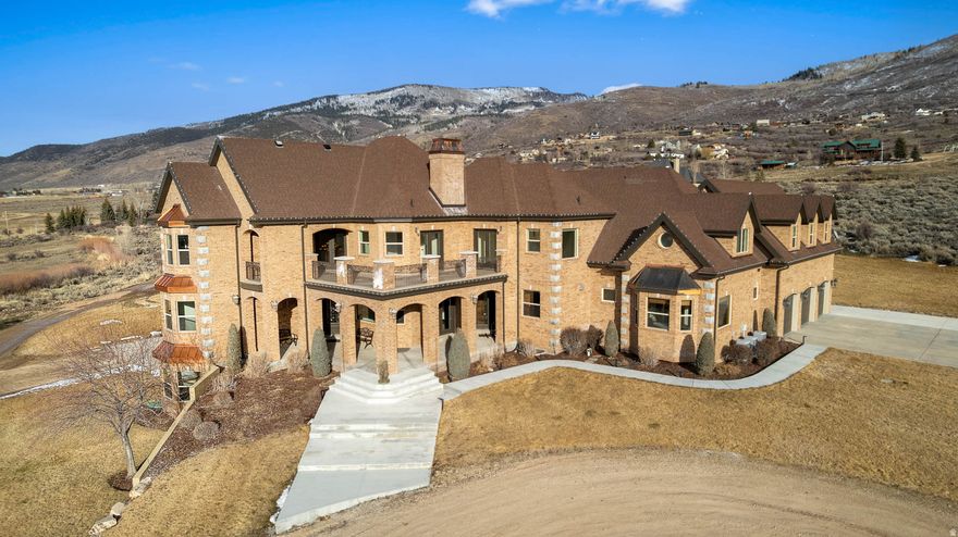 Priced below appraisal value of $7.17m!  This beautiful Kamas estate is situated on 17 acres and features 11 bedrooms, 10 bathrooms, and space for 5 cars in the two garages. This includes a lower-level 2-bedroom plus office, 2 bathroom ADU, a family/media room on each level and an open-concept layout with high ceilings, exposed beams, floor-to-ceiling windows, and multiple walkout points to decks and patios designed to maximize views of surrounding peaks and the valley. The family thought of everything - an elevator for all 3 floors, laundry chute, even a winch to lower the entry chandelier for easier cleaning. property features 17 expansive acres (some still in greenbelt status), offering potential for equestrian facilities, a hobby farm, or enjoying the natural landscape and views unique to the Kamas Valley. The property comes with water shares, a newly drilled well, 3 buried propane tanks (no natural gas), 8 furnaces, 8 a/c's, and a private gated driveway easement for the 2 homes on this lane. Located minutes from the Mirror Lake Scenic Byway and 20 minutes from Park City. Additional acreage may be available if interested. Shares of Smith and Moorehouse Reservoir Company and 3.53 shares of Marion Upper Ditch to be included.  Square footage figures are provided as a courtesy estimate only and were obtained from appraisal .  Buyer is advised to obtain an independent measurement.