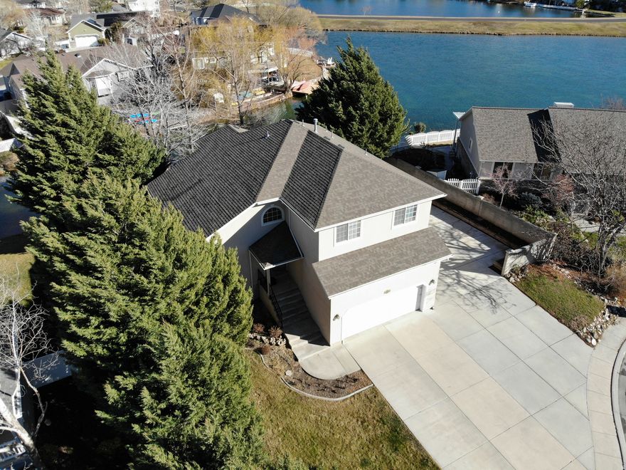 Wake up to shimmering water and end your days dockside. Highly desirable lakefront home with private dock for fishing, swimming, and paddleboarding. Open floor plan with vaulted ceilings, 5 bedrooms, and a newer roof and HVAC. The basement offers excellent apartment potential with its own entrance. The basement includes 2 finished bedrooms, and the remaining space is taken to the four-way point, with plumbing and electrical in place for a kitchenette, bathroom, and laundry. Located in a sought-after lifestyle community featuring a pool, clubhouse, golf course, and more. NOTE: Seller will be doing a 1031 Exchange on this property.   Square footage figures are provided as a courtesy estimate only and were obtained from the County Records .  Buyer is advised to obtain an independent measurement.