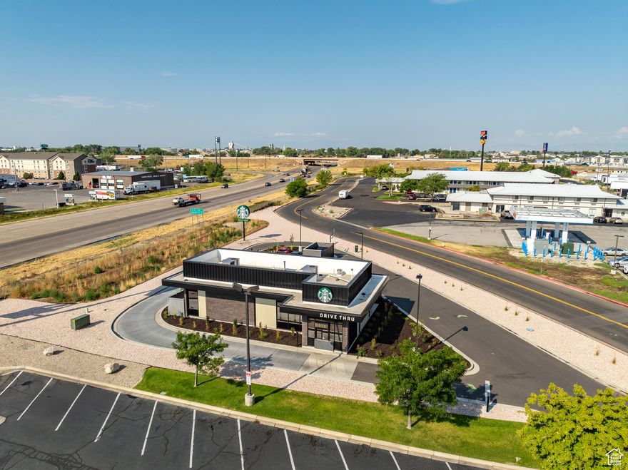 Brand-new Starbucks flagship property in a premier Utah corridor, offering a NN+ investment with one of the world's most recognized brands. Completed in 2024, this first-of-its-kind drive-thru concept is positioned at a high-visibility, high-traffic I-15 / I-84 interchange, delivering unparalleled access for commuters and travelers alike. The asset features a 10-year initial term with four 5-year renewal options extending through 2055, coupled with a 60% total rent increase across the term and built-in rent growth to hedge against inflation. The investment is secured by Starbucks corporate with a proven 50+ year operating history, ensuring stable current income and substantial appreciation potential as cap rate expands from 4.86% to 7.83% over the lease term. Co-located with McDonald's, this premier quick-service restaurant (QSR) asset offers portfolio diversification and a truly passive, institutional-quality opportunity backed by a global brand leader. Ownership is fee simple, granting full control of a premium corner location and immediate scale within a growing market. With exceptional visibility, access, and a premium corner site, this Starbucks property is designed to deliver durable income, inflation protection, and significant long-term upside.