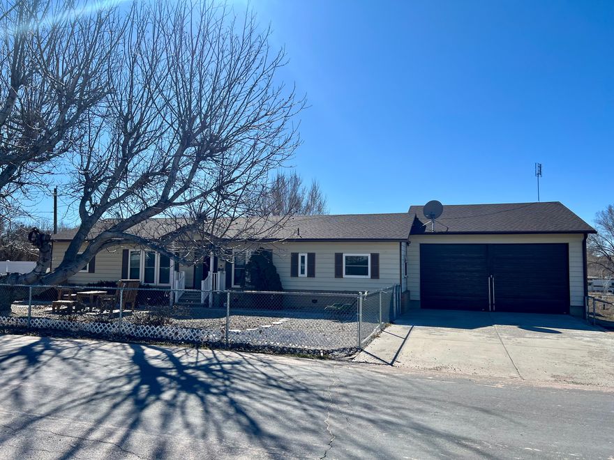 INTERIOR PICTURES ARE COMING; SELLER IS CLEANING OUT THE HOME. You need to see this spacious 3 Bdrm, 2 bath home on a large .34 acre lot with an oversized attached 2 car garage with workshop area! Kitchen appliances are only about 1 year old! Fully fenced yard, RV parking, & covered patio in the back yard. Extra side yard that is fenced has fruit trees (peach & apple) and could be used for a garden area, extra parking, play area, etc. There are motion detector & security lights outside.