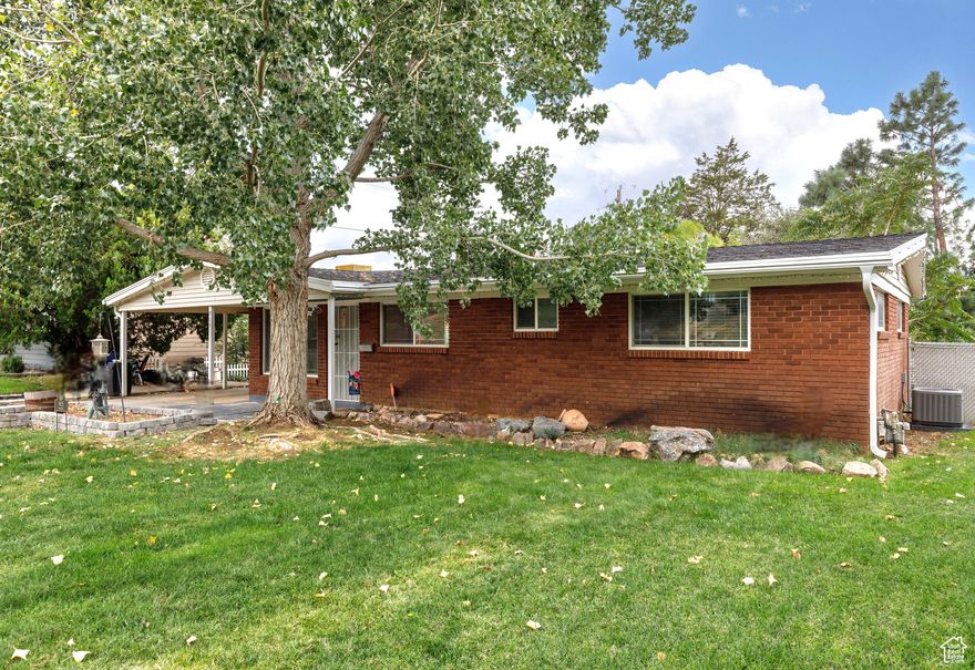 This home is the perfect blend of classic charm and modern updates! Tucked into Ogden's East Bench, 915 Hislop Drive is a 3-bedroom, 2-bath, 1,651 sq. ft. single level living rambler that has been thoughtfully remodeled inside and out. Originally built in 1954, the home has seen major upgrades in the last five years, including a brand-new AC, kitchen appliances, RO water in kitchen, Shed with power, updated interior plumbing, new fireplace insert, water heater, water softener, a spacious new deck with pergola, and leaf guard gutters. Inside, you'll find engineered hardwood floors, updated bathrooms, and a bright open-concept living space designed for gatherings. The oversized master bedroom features French doors leading to the backyard retreat. Step outside to enjoy your sunsets, mature landscaping, and two storage sheds - all with gorgeous mountain views from the front and sweeping vistas to the west. This home is move-in ready and offers the comfort of single-level living in a peaceful neighborhood.  The covered carport offers additional storage and parking for toys and vehicles.