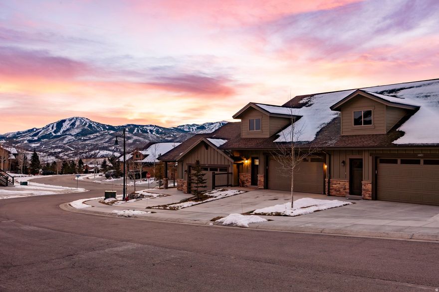 As the sun sets over the ridgeline of Park City, the light pours through west-facing windows, bathing the living room in gold. Your evening begins on the covered deck, drink in hand, taking in one of the best views in the entire Black Rock Ridge community as you watch the ski slopes light up in the alpenglow. Real hardwood floors guide you into a kitchen designed for both form and function, with rich wood cabinetry, granite countertops, and a sleek gas range. Fresh pendant lighting sets the tone while you brew your coffee and watch the mountain skyline shift with the sunrise. In winter, you return from the slopes and step into a fully finished garage; epoxy floors clean and durable, with dedicated storage for skis, boards, and boots. In the primary suite, the steam shower awaits, turning your post-ski ritual into a spa experience. With three bedrooms and a theater room, the layout flexes easily for hosting or relaxing. Everything is thoughtful, from vaulted ceilings that elevate the great room to the quiet privacy of your patio-level hot tub under the stars. Black Rock Ridge's central location allows its residents and guests to enjoy all aspects of living in the Wasatch Back. Not only are you just minutes from Main Street and Deer Valley East Village, but the trails of the Uinta National Forrest and the Heber Valley are a short drive away for you as well. Need to go anywhere else in the world? The Salt Lake City International Airport is only 35 minutes away.
