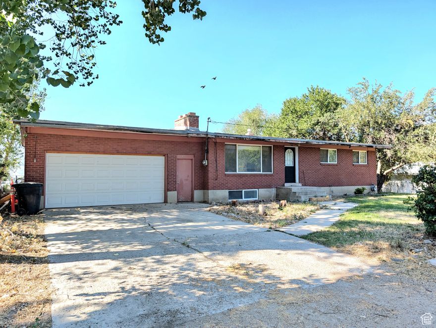 Your Midway Makeover Awaits! Tucked in a coveted location just steps from downtown Midway, this 1960s red brick rambler is brimming with character and potential. With 5 bedrooms, 2 baths, and two wood-burning stoves, it's the perfect canvas for someone ready to bring fresh life to solid, well-built bones. The expansive backyard- with mature fruit trees-invites summer gatherings, gardens, or simply a peaceful private retreat. A 2-car garage adds practicality, while the setting delivers charm in every direction. If you've been searching for "the one" to make your own, this is the perfect project home in the perfect spot.  Square footage figures are provided as a courtesy estimate only and were obtained from public records. Buyer is advised to obtain an independent measurement.