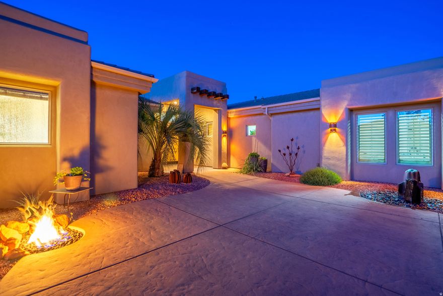 Welcome to this 3,386 SF singlelevel residence which showcases exceptional craftsmanship and some of the most soughtafter views in Southern Utah. From the solid Acacia wood flooring (one of the hardest and most durable woods available, naturally moistureresistant and visually striking) to the solid knotty alder wood doors, custom knotty alder cabinetry, and exquisite stonework throughout, every detail reflects quality construction and thoughtful design.  Soaring ceilings and expansive windows in the living room frame unobstructed views of the red rock mountains while surrounding a beautiful fireplace. Just beyond, the private pool, spa, outdoor BBQ, and tranquil water feature create a seamless extension of the indoor living experience. With the inclusion of the private pool, the zoned HVAC system ensures elevated comfort yearround, enhancing both efficiency and livability.  At the heart of the home, the gourmet kitchen continues the theme of thoughtful craftsmanship. A doubleisland layout provides generous workspace and effortless flow, while abundant storage, a walkin pantry, and a dedicated wine/beverage room elevate both everyday convenience and entertaining potential.  For outdoor enthusiasts, the location is unmatched. With approximately 29 scenic hiking and biking trails in the immediate area, many accessible directly from the surrounding Red Cliffs Desert Reserve and nearby Snow Canyon State Park, you're steps away from worldclass recreation. Popular options include the Padre Canyon Trail, Johnson Canyon Arch Trail, and the Whiptail Trail, along with notable destinations such as the Anasazi Valley Trailhead for viewing ancient ruins and the Chuckwalla Trail leading to Scout Cave.