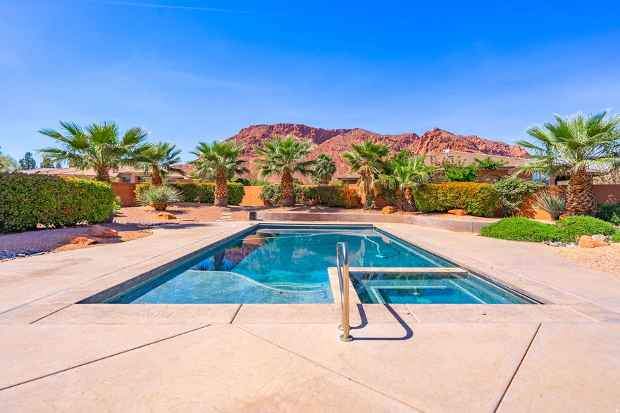 Welcome to this 3,386 SF singlelevel residence which showcases exceptional craftsmanship and some of the most soughtafter views in Southern Utah. From the solid Acacia wood flooring (one of the hardest and most durable woods available, naturally moistureresistant and visually striking) to the solid knotty alder wood doors, custom knotty alder cabinetry, and exquisite stonework throughout, every detail reflects quality construction and thoughtful design.  Soaring ceilings and expansive windows in the living room frame unobstructed views of the red rock mountains while surrounding a beautiful fireplace. Just beyond, the private pool, spa, outdoor BBQ, and tranquil water feature create a seamless extension of the indoor living experience. With the inclusion of the private pool, the zoned HVAC system ensures elevated comfort yearround, enhancing both efficiency and livability.  At the heart of the home, the gourmet kitchen continues the theme of thoughtful craftsmanship. A doubleisland layout provides generous workspace and effortless flow, while abundant storage, a walkin pantry, and a dedicated wine/beverage room elevate both everyday convenience and entertaining potential.  For outdoor enthusiasts, the location is unmatched. With approximately 29 scenic hiking and biking trails in the immediate area, many accessible directly from the surrounding Red Cliffs Desert Reserve and nearby Snow Canyon State Park, you're steps away from worldclass recreation. Popular options include the Padre Canyon Trail, Johnson Canyon Arch Trail, and the Whiptail Trail, along with notable destinations such as the Anasazi Valley Trailhead for viewing ancient ruins and the Chuckwalla Trail leading to Scout Cave.