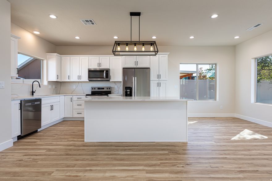 FINISHED!!! This new construction home is an affordable solution for solving the office, workout room, art studio, a special space for your furry friends or just kid space. Here is your solution. This is a size down or size up home which will be easy on your pocketbook. Come look at this beautifully crafted 3-bedroom, 2-bath gem! This property offers an unparalleled blend of comfort and adventure. The spacious open-concept living area boasts sleek quartz countertops throughout, luxury vinyl plank flooring, a large kitchen island, for entertaining or your culinary creations. The primary bedroom features an ensuite bath, ensuring your private oasis. Enjoy outdoor living on the covered patio and secluded yard. You will love ample space for entertaining indoors or out. Plus, you're just steps away from breathtaking hiking trails. Home is finished and ready to make your dreams come true. Don't miss this chance to own a piece of paradise! Located near the national parks of Southern Utah, Best Friends Animal Sanctuary & Lake Powell and the Grand Canyon. Buyer will want to verify all details.