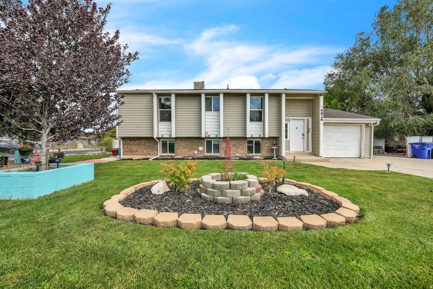 No Showings unless under contract. Home is No-Show Active.  TWO KITCHENS + ADU COMPLIANT + RENTAL INCOME! This versatile property offers a fully finished 2-bedroom basement apartment with its own private entrance-currently rented for $1,500/month-making it perfect for investors, house hackers, or multi-generational living. The main level provides an inviting open-concept layout that flows onto an elevated deck overlooking the nearly quarter-acre lot and fully fenced backyard-a great space for gatherings and quiet evenings. The basement unit is completely self-contained with an open kitchen, dining, and living area, 2 bedrooms, a bathroom, and laundry-designed for privacy and functionality. Additional highlights:  ADU compliant for long-term rental security  Extra-deep garage with A/C  Parking for up to 10 vehicles  Smart thermostat  Security system with full exterior & landscape lighting  With a tenant already in place helping cover your mortgage, this property not only provides immediate income but also supports long-term wealth building through appreciation and equity growth. This home is the perfect blend of comfortable living and income-producing opportunity. Don't miss it!