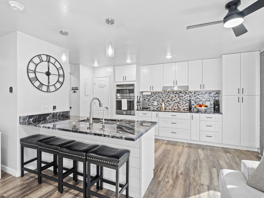Come see this beautifully updated townhome in Spanish Fork! Featuring 4 bedrooms and 3.5 bathrooms, this home is in excellent condition and offers a rare blend of high-end upgrades, thoughtful design, and spacious, functional living.  As soon as you walk in, you'll notice the home's fresh, modern updates, stylish finishes, and bright, welcoming feel. The kitchen is the heart of the home, featuring beautiful white cabinets, upgraded granite countertops, brand-new stainless steel appliances, and a large peninsula perfect for meals, gathering, and entertaining. A built-in reverse osmosis system provides clean, high-quality drinking water. Step outside to your own spacious private deck, made for relaxing or entertaining year-round, complete with a retractable pergola and shade canopy for added comfort and style.  Enjoy a fresh, fully updated interior featuring brand-new carpet and flooring throughout, complemented by modern light fixtures. The home has been recently repainted, creating a clean feel in every room. Custom-made blackout honeycomb blinds on all windows add both style and energy efficiency. All windows are fitted with privacy mirror film, offering enhanced privacy while still allowing natural light in.    The fully finished basement is a standout feature, offering a private Mother-in-law apartment. This rare space includes a second kitchen with new appliances and is perfect for extended family or guests! The attached two-car garage features a brand-new opener with track and plenty of overhead storage, offering endless flexibility for extra storage, a home gym, or even a fun hangout space with room for a kids' hammock setup.  This home provides easy access to all the amenities Spanish Fork has to offer for your family. Conveniently located minutes away from the hospital and the freeway!  Don't miss the chance to live a life of luxury-schedule your private tour today. Even better? All appliances are included!. This home is a MUST SEE!