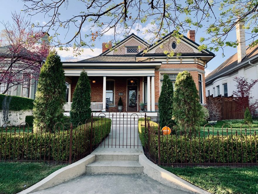 Gracefully located in the heart of Salt Lake City's beloved Avenues neighborhood, this classic Victorian residence captures the romance and architectural charm that define the area while offering exceptional modern refinement. Meticulously updated with a discerning eye for design, the home blends historic integrity with sophisticated contemporary living. Original architectural details remain beautifully preserved and pair seamlessly with elevated interiors, high-end finishes, and thoughtful craftsmanship. The versatile floor plan offers inviting spaces for everyday living as well as elegant entertaining. The updated kitchen features pro appliances, a pantry and opens to a warm and inviting hearth room, an ideal gathering space for casual living and conversation. The primary suite feels truly inviting and offers a stunning marble bath and custom walk-in closet with built-in cabinetry. On the lower level, there are two more bedrooms, bathroom, and flex space. A tucked-away music parlor creates an atmospheric retreat, perfect for a cigar lounge, wine cellar, poker room, or whiskey library. Outside, a charming European-inspired garden unfolds with multiple areas for outdoor dining, entertaining, and quiet retreat, all within a fully fenced setting. The home includes a two-car garage with additional storage and easy alley access. Recognized on the historic register, this home preserves the elegance of a classic Avenues Victorian while delivering a fully dialed-in living experience, sophisticated and comfortable. Walkable to outdoor recreation, biking, running trails, downtown shopping,, restaurants and nightlife. Minutes to freeways and airport.