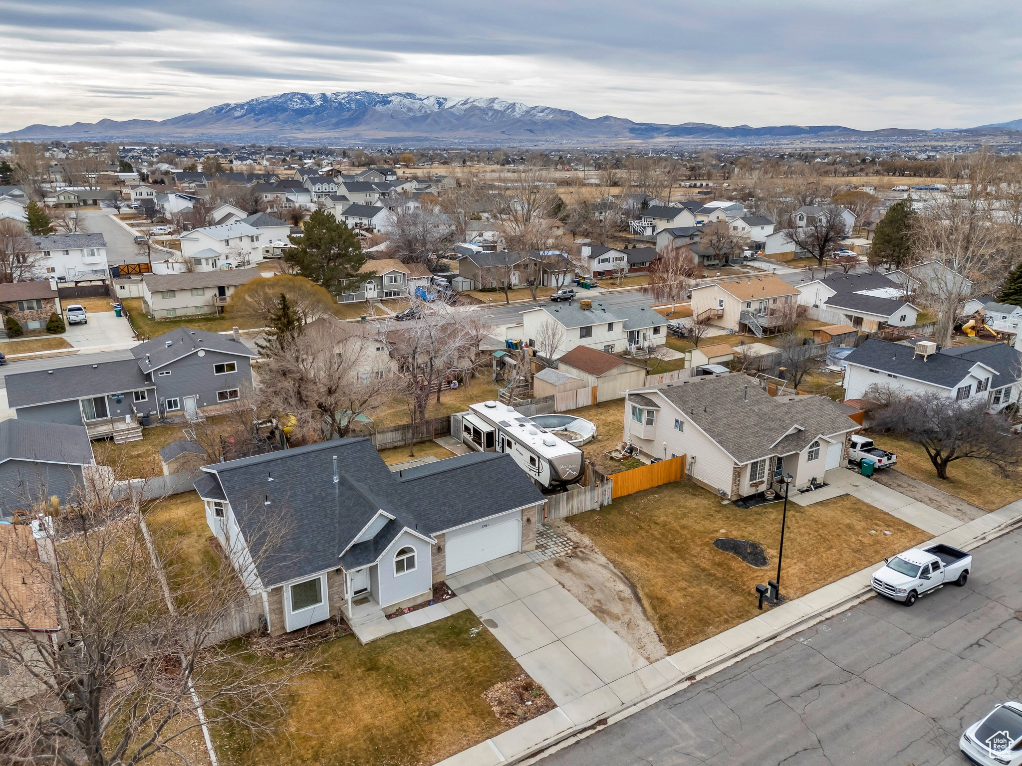 Get ready to fall head over heels for this gem of a home! Nestled in the heart of Lehi, this isn't just a house, it's a lifestyle upgrade! Imagine: top-rated schools and hospitals, retail therapy just minutes away, and freeway access that makes commuting a breeze. But the real magic happens inside... Step inside and be greeted by a home that's been updated! We're talking NEW windows, a NEW roof, and a NEW HVAC and AC unit  talk about worry-free living! The heart of this home? A stunning, fully remodeled kitchen boasting crisp white cabinets, gleaming quartz countertops, and sleek stainless-steel appliances.  Downstairs, a spacious family room awaits, perfect for movie nights or epic game days. A bright bedroom and updated bathroom with a walk-in shower complete the lower level, offering a private retreat. The basement has lots of natural light, making it feel open and inviting. Upstairs, three bedrooms offer plenty of space, with the primary bedroom having a private entrance to the updated main bathroom. Outside, prepare to be wowed! A paver patio beckons with its charming gazebo  the perfect spot for summer BBQs and starlit conversations. Got toys? We've got you covered with RV parking and hookups, plus a handy shed for all your gear. And for the green thumb? Spring and summer bring a riot of color with vibrant flowers blooming throughout the yard. Let's not forget the oversized garage! Complete with a workbench and new overhead shelving, it's a dream come true for any DIY enthusiast.