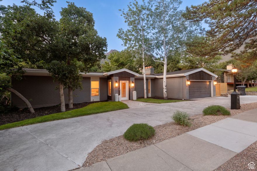 One of a kind mid-century California modern rich in character. Simplistic clean lines, open spaces, beamed wood plank vault and walls of glass framing a wooded setting are just the beginning. A brick and terrazzo fireplace warms the intimate dining room while the massive glass "great room" feels like a Hollywood Hills entertainment pad. The formal and casual living spaces are all open and connect with ease. The house sits in a grove of beautiful tall scrub oak with huge, fabulous deck and patio spaces set up for amazing outdoor living. There is even a deluxe putting green - a replica of the Pebble Beach par 3 seventh hole. The kitchen and baths are modern and perfect. The layout offers up to six bedrooms plus a bonus room. The media/theatre space is tucked away with the ultimate cozy movie vibe. Both levels are at one with the setting with an indoor/outdoor flow. The primary suite has a fantastic dressing room, a crisp modern bath, private deck and a sense of serenity. This is the ultimate quick access location right at the base of the canyons! Note the circular drive, new fencing and ultra custom landscaping.