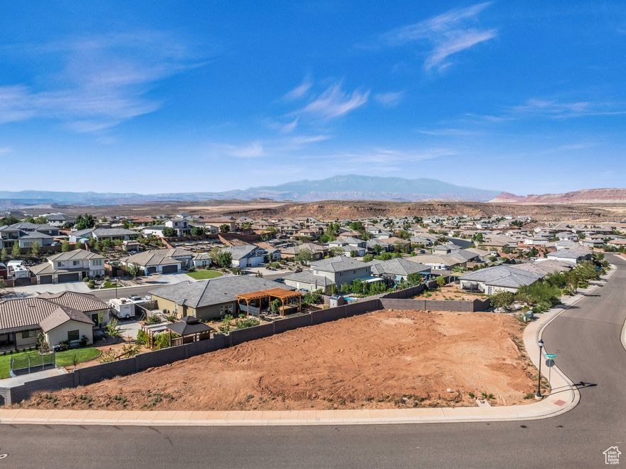 Beautiful, elevated view lot nestled in the highly desirable Desert Point at Desert Canyons. This stunning 0.30-Acre corner lot offers breathtaking mountain views and the serenity of a quiet neighborhood-all with NO HOA dues. Bring your vision to life with your own builder in this custom home phase, the lot is already pad-ready with the county water fee paid. Enjoy the convenience of flat terrain, perfect for building the home of your dreams! Located in the Dixie Power service area, this exceptional lot truly stands out as one of the best in all of Southern Utah!! Buyer to verify all information, deemed reliable, however buyer to verify all info including utilities, rental restrictions, and HOA information if applicable.
