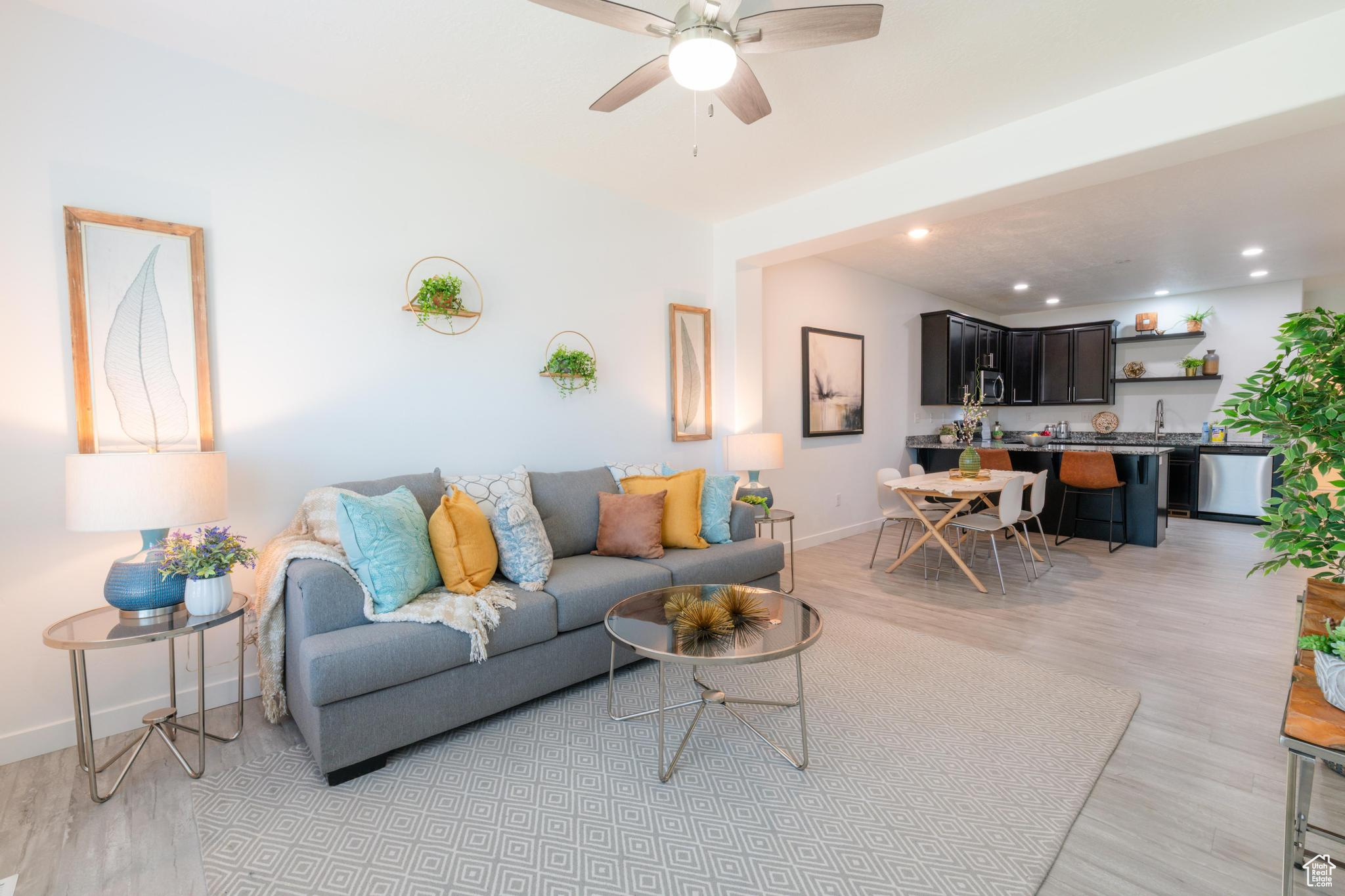 This well-maintained 3-bedroom, 3-bath townhome in Vineyard's vibrant Edgewater community is a must-see! With new carpet and fresh paint throughout, this 2019 home offers a spacious floor plan featuring a bright main-level family room with easy garage access. The second level boasts an open-concept great room, sleek modern kitchen with granite countertops and stainless appliances, a dining area perfect for entertaining, plus a guest bedroom and full bath. Upstairs you'll find a large primary suite with dual walk-in closets and double-sink bathroom, a secondary ensuite bedroom with full bath and walk-in closet, and a conveniently located laundry room. Community amenities include a pool, hot tub, clubhouse with kitchen and theater, gym, pickleball and basketball courts, playgrounds, and walking paths. Prime location near Top Golf, professional offices, dining and Megaplex Theaters, with easy access to I-15, Frontrunner, shopping, and UVU. This move-in ready townhome offers a no-neighbor entry, blending comfort, convenience, and community living. Schedule your personal tour today or join us at the open house Saturday, Sept. 6, from 11am 1pm. *Measurements taken from floor plans; County records show 1906 sq feet. Buyer advised to verify.