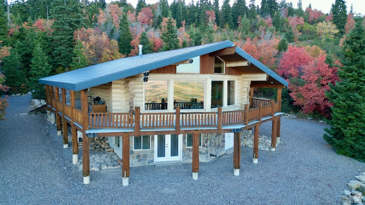 Escape to your own private retreat with this stunning 2,600 sq. ft. log cabin nestled on 4.63 wooded acres in the exclusive Legacy Mountain community. Surrounded by towering pines and vibrant maples, this 3-bedroom, 2-bath home offers both seclusion and breathtaking views. Inside, you'll find a spacious open layout with expansive windows that frame the surrounding forest and mountain vistas. Warmth and comfort are ensured year-round with a pellet stove and wood stove. The durable metal roof provides peace of mind in every season. Enjoy the outdoors from the expansive wraparound deck or relax by the gated driveway that ensures privacy and security. Two 1,000-gallon underground backup water tanks provide added self-sufficiency, making this property perfect for a year-round residence or a mountain getaway. Whether you're drawn by the fresh mountain air, vibrant fall colors, or the serenity of forest living, this Legacy Mountain cabin delivers unmatched beauty and seclusion.