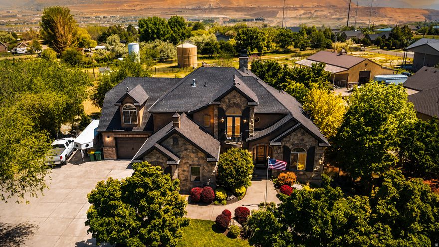 Experience elevated living in this stunning Bluffdale estate, where luxury, comfort, and space come together in perfect harmony. Set on over an acre of pristine land, this remarkable property offers privacy, versatility, and the rare opportunity for equestrian use with ample room for horses, additional structures, or a custom outdoor retreat. Inside, the home showcases a thoughtfully designed layout with 6 spacious bedrooms and 5 beautifully appointed bathrooms, providing both functionality and elegance for everyday living and entertaining. At the heart of the home is a stunning kitchen, designed to impress with its upscale finishes, generous workspace, and seamless flow into the main living areas perfect for hosting or enjoying quiet nights in. A cozy fireplace anchors the main living space, adding warmth and inviting ambiance. The recently finished walk-out basement is a true showpiece, featuring soaring 12-foot ceilings that create a bright, expansive environment rarely found in lower levels, along with a custom wine cellar that adds a refined, luxurious touch.Every detail has been curated for comfort and convenience, including permanent LED EverLights that enhance the home's exterior with year-round ambiance and effortless holiday lighting. Step outside to your private backyard retreat, complete with a large deck and water feature, a 10-foot fence surrounds the entire property for exceptional privacy. Enjoy the wide-open space, breathtaking surroundings, and peaceful atmosphere that only a property of this size can offer. Whether you're entertaining, relaxing, or embracing a more open lifestyle, this estate delivers an unmatched living experience. A rare blend of luxury finishes, modern amenities, and expansive land-this Bluffdale property is truly one-of-a-kind.
