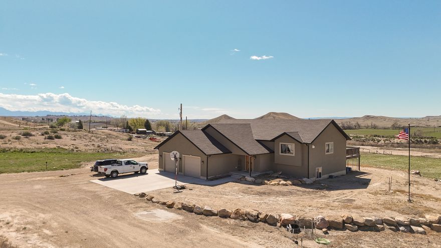 A rare blend of privacy, acreage, and proximity to town. This well-appointed home features 5 bedrooms, 3 baths, an office, an oversized 2-car garage, and a daylight basement with a huge family room and abundant storage. Two pastures, pressurized irrigation, and water shares included at this price (1 Scofield, 1 Carbon Canal). The open great room showcases vaulted ceilings, tile floors, stainless appliances, staggered cabinetry, a breakfast bar for 4, built-in display shelving, a gas fireplace, and panoramic windows framing forever mountain and valley views. Large deck positioned to take full advantage of the scenery. Main level includes 2 bedrooms, an office, and a large walk-in pantry; lower level adds 3 bedrooms and a full bath. Square footage from county records; buyer to verify.