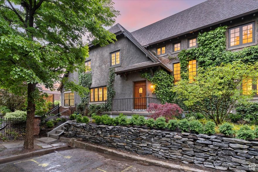 Haxton Place holds an enduring and distinctive place in Salt Lake City's legacy. You'll be carried away to another time and place as you pass through the sandstone archways at the corner of South Temple and Haxton Place. The picturesque cul-de-sac is lined with stately homes and a canopy of mature trees, reminiscent of a prestigious English enclave. In 1909, the street was touted as "One of the most handsome and exclusive residence sections in the city"  in Goodwin's Weekly Newspaper. The homes were described as "Graceful expressions of utility" by the Salt Lake Herald Republican in October of 1909. While it's been more than a century since these statements were printed, they still hold true.  The ivy-covered estate holding court at the far end of the lane is 35 Haxton Place. 35 Haxton Place on the east side and 34 Haxton Place on the west side. Each of these properties are currently available for sale.   Built in 1907 for members of the city's high society, these halls exude an air of historical significance. Many elements of the original craftsmanship continue to shine, such as the grand staircase and exposed beam ceilings, validating its place on the National Historic Register.     The current owners have gone to great lengths to accurately restore the home to its proper state of grandeur. They carefully researched the home's provenance before refurbishing original elements such as the light fixtures and woodwork. Many practical modern updates have been made in recent years as well, such as the well-appointed kitchen that glows with natural light.   Newly completed professional landscaping of the side yard aligns perfectly with the home's historic character and provides the perfect setting for garden parties. A greenhouse is attached to the lower level of the home for year-round gardening and a two-car garage can be accessed through an alley.  Surrounded by historic homes and an immaculate garden, you will likely forget that you're just a stone's throw from downtown. Salt Lake City's finest restaurants and cultural institutions are minutes away. A quick drive up South Temple will take you to the University of Utah.   This property is a treasured piece of Salt Lake City's history, a testament to the enduring power of quality craftsmanship. It also holds the promise of a bright future, with many more stories to write.