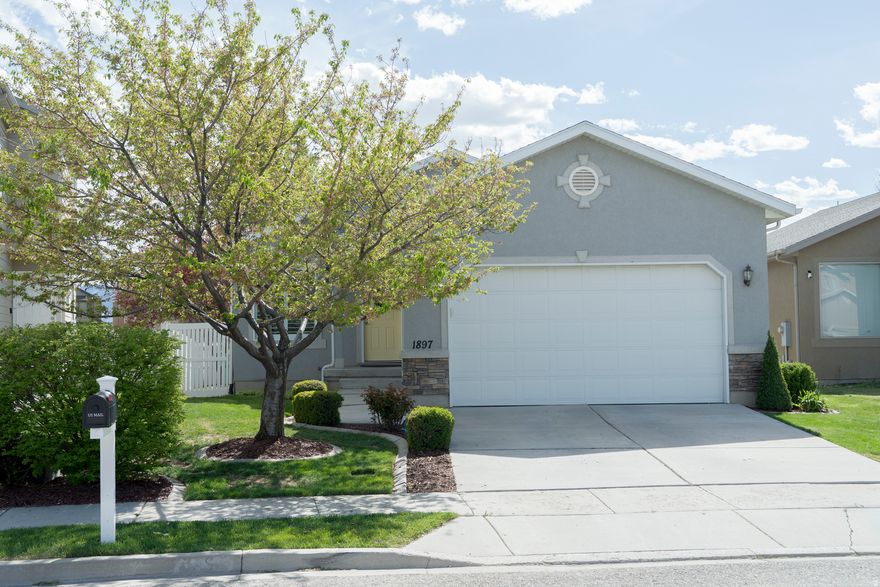A beautifully designed rambler in the heart of Lehi-one of Utah County's fastest-growing and most desirable communities. Perfectly positioned, this home offers the ideal blend of comfort, convenience, and access to everything that makes the area so special. Step inside to discover a thoughtfully laid-out main level featuring 3  bedrooms and 2 full bathrooms, providing easy single-level living. This functional floor plan is complemented by a large attached 2-car garage and plenty of natural light throughout. Downstairs, you'll find a fully finished family room-perfect for entertaining, relaxing, or creating the ultimate movie or game space. The basement also offers room to expand with additional bedroom space and is already stubbed for a future bathroom, giving you incredible equity-building potential and flexibility to customize the home to your needs. Location is where this home truly shines. Just minutes away, Thanksgiving Point serves as a year-round destination featuring stunning gardens, museums, golf, dining, and entertainment. Nearby shopping and dining options-including the popular Traverse Mountain area-provide everyday convenience and lifestyle appeal. For outdoor enthusiasts, you'll love the easy access to the scenic Jordan River Parkway Trail, a paved, year-round trail perfect for walking, biking, and exploring the natural beauty of the area . The surrounding region is known for its balance of urban convenience and outdoor recreation, making it a standout place to live. Commuters will appreciate the home's proximity to I-15 and the thriving "Silicon Slopes" tech corridor, offering quick access to major employers and a central location between Salt Lake City and Provo. Whether you're looking for move-in-ready comfort or a home with room to grow, this property offers the best of both worlds-space, location, and long-term potential-all in one exceptional Lehi neighborhood.
