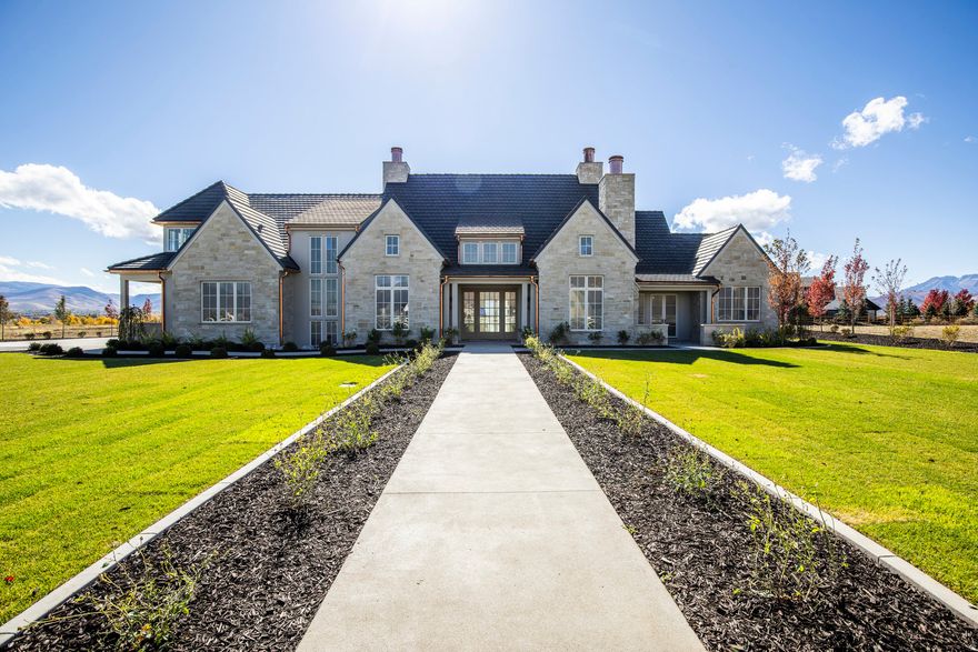 Welcome to 802 E. Stone Barn Lane, a stunning new construction home located in the highly sought-after Whitaker Farm neighborhood in Midway. Built by the esteemed NB Design Build and thoughtfully designed by the acclaimed Curtis Design Group, this home offers the perfect blend of luxury and comfort. Boasting a spacious, open floor plan, this residence is flooded with natural light thanks to its abundant large windows that provide sweeping views of the surrounding landscape. The primary bedroom suite is a true retreat, featuring a spa like en-suite bathroom and direct access to a covered patio, ideal for enjoying the serene outdoor surroundings. The main level also includes a beautifully appointed casita guest bedroom suite with its own private entrance, a cozy hearth library room, a private office, and a generously sized three-car garage with ample room for storage. Upstairs, two more well-proportioned bedroom suites offer comfort and privacy for family or guests. The lower level of the home features a welcoming family room with a wet bar, along with a separate exercise area, creating an ideal space for both relaxation and active pursuits. Builder also has plans for a separate 900 sq. ft. boat/RV garage with a workshop that can be added during or after construction. With its exceptional craftsmanship, thoughtful design, and expansive outdoor living spaces, this home exemplifies modern elegance in one of Midway's most desirable neighborhoods.