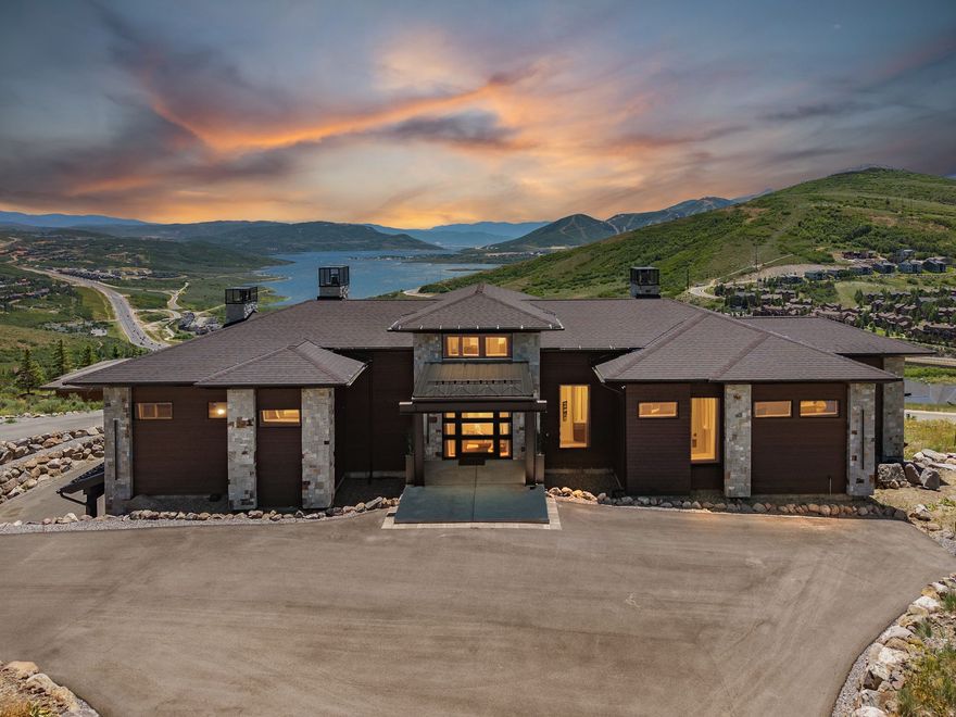 Set high above the Jordanelle with sweeping panoramic views, this newly completed contemporary residence in the gated Deer Vista community offers an exceptional blend of modern architecture, privacy, and proximity to the expanding Deer Valley East Village. Built in 2024 by Modern Builders, the 4,555 sq ft home was designed to capture the surrounding landscape from nearly every room, showcasing dramatic vistas of the Jordanelle Reservoir, Deer Valley ski runs, and the rugged Wasatch mountain range. The home features 4 spacious bedrooms and 6 bathrooms, with a thoughtfully crafted floor plan that emphasizes natural light, clean lines, and open gathering spaces. Expansive windows and soaring ceilings create a bright, airy environment while framing the extraordinary alpine scenery that defines this location. Outdoor living is equally impressive, with generous patio and deck spaces ideal for hosting guests, enjoying quiet mountain mornings, or watching vibrant sunsets over the lake and peaks. The seamless connection between indoor and outdoor spaces allows the home to be enjoyed in every season. Located just minutes from the new Deer Valley East Village base area, residents enjoy convenient access to world-class skiing, dining, hiking, boating on Jordanelle Reservoir, and endless four-season recreation. Combined with the privacy and security of a gated enclave, this home delivers a rare opportunity to experience contemporary mountain living in one of the most exciting growth corridors in the Park City area. A refined retreat where modern design meets iconic Utah mountain views.