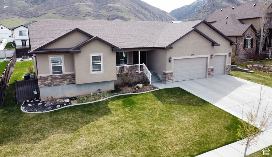 Don't miss this incredible deal on a beautiful 4,057 sq. ft. rambler on the sought-after southeast Tooele bench! You'll love the breathtaking mountain and valley views and the home's brand-new LVP flooring throughout the main level.  This spacious home offers 9 bedrooms & 4 bathrooms, giving you plenty of room to live, work, and play. The open-concept floor plan is perfect for entertaining large gatherings, & the west-facing orientation means you can relax in the cool shade of the backyard all summer long.  The professionally finished basement-just one year new-adds even more versatile living space, ideal for a home theater, gym,  bedrooms, or storage.   Step outside to a fully fenced 0.32-acre yard that's perfect for family fun, complete with a swing set, trampoline, shed, and apple trees. Whether you're hosting a barbecue or enjoying quiet evenings taking in the mountain views, this home has it all.