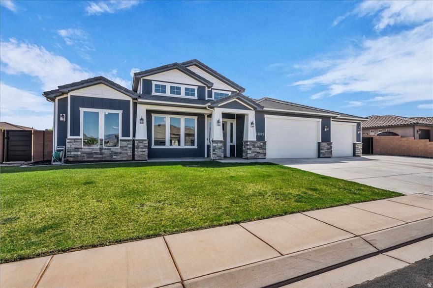 Beautifully designed with striking curb appeal, this home welcomes you into a thoughtfully crafted open layout that feels both spacious and refined. Soaring ceilings and elegant coffered details enhance the bright, open-concept living area, where natural light and tile flooring create a warm, inviting space perfect for both everyday living and effortless entertaining. At the heart of the home, the kitchen offers a seamless balance of beauty and function, featuring beautiful, high-end cabinetry, an expansive island ideal for gathering, quartz countertops, and a generous butler's pantry designed for exceptional storage and organization. The primary suite offers a private retreat with a dual vanity, soaking tub, and walk-in shower, while the laundry room continues the home's elevated feel with custom cabinetry and quartz finishes. A spacious 3-car garage features extra depth for a potential fourth bay, 9 ft doors for larger vehicles and toys, electric car charger hookups, and ample storage, along with gated RV parking. Enjoy a fully enclosed backyard designed for both relaxation and entertaining, where a covered patio, detached gazebo, and hot tub create the perfect setting to unwind or host under the Southern Utah sky. Situated near stunning red rock landscapes, this home offers a peaceful setting with no HOA and direct access to ride UTVs from the property--just minutes from Sand Hollow State Park, Sand Hollow Golf Course, the dunes, and popular rock crawling areas. Buyer/buyer's agent to verify all information.