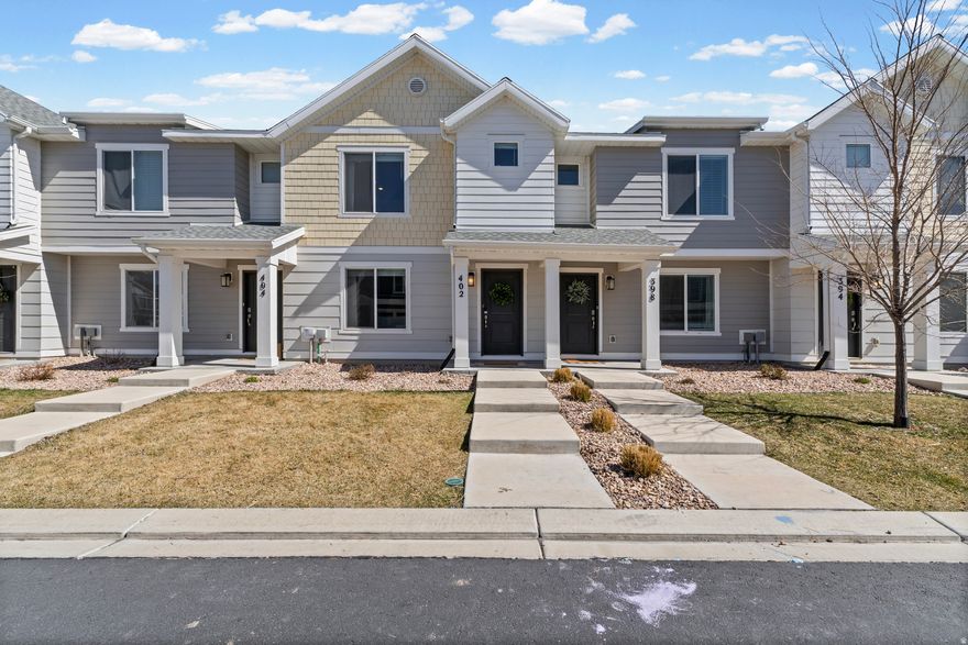 Lovely newer-built townhome in Saratoga Springs now available. From the moment you step inside, you will instantly fall in love with the bright, modern open-concept layout that seamlessly connects the kitchen and family room, creating a warm and inviting space perfect for everyday living and entertaining. The family room is spacious and filled with natural light, making it an ideal place to relax or gather with friends and family. The kitchen is a true standout, featuring a large quartz island with bar seating, modern flooring, a gas range, stainless steel appliances, and a spacious walk-in pantry. The semi-formal dining area is thoughtfully positioned, offering both functionality and style for hosting meals and gatherings. Upstairs, the primary suite is generously sized and filled with natural light, creating a comfortable retreat. The en-suite bathroom features a quartz vanity, a full bath, and a large walk-in closet. You will also find two additional bedrooms, including one with a walk-in closet, along with a full bathroom and convenient upstairs laundry. The unfinished basement provides incredible potential, offering the flexibility to create additional living space, a home office, gym, or recreation area tailored to your needs. Located in a highly desirable area, this home is just minutes from Saratoga Springs amenities including Costco and Home Depot, Costa Vida, while also offering quick access to American Fork shopping, dining, and entertainment such as Target, In-N-Out, and more. This home offers the perfect combination of modern design, functional space, and prime location. Schedule your private showing today before it is gone. Buyer and Buyers agent to verify all information. Square footage figures are provided as a courtesy estimate only. Buyer is advised to obtain an independent measurement.