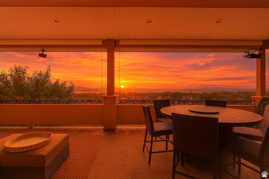 Price Improvement!  This Home Has It ALL *MILLION DOLLAR VIEWS & Ultimate Garage Space!  Enjoy breathtaking panoramic views of Willard Bay, the Great Salt Lake, and majestic mountain peaks with unforgettable sunsets every night!   Key Features:  *MASSIVE RV GARAGE (1,000+ sq ft) *Your dream, heated, man cave! Easily fits a 40-foot motorhome, boat, truck, and all your toys. *MAIN LEVEL 2 CAR GARAGE - Also Heated *MOTHER IN LAW RETREAT with a full kitchen and private walkout entrance perfect for guests or rental income. *COVERED DECK with built-in natural gas for BBQ ideal for entertaining.  *LOW MAINTENANCE LANDSCAPING with efficient drip irrigation system. *OPTIONAL FURNISHINGS Negotiable for a truly turn-key move-in. EXTRAS:  Elegant glass fireplaces, Designer lighting and ceiling fans, Premium travertine flooring and luxurious tile finishes throughout.  This home blends comfort, luxury, and functionality in a way that's rarely seen. Whether you're entertaining, storing your toys, or soaking in the sunset, this is the one you've been waiting for.