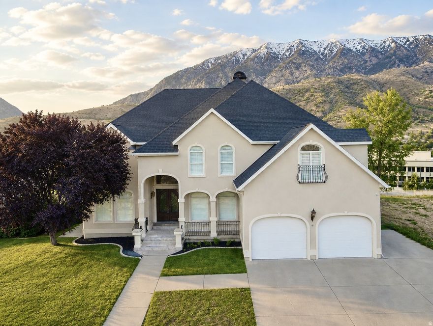 Rare combination of size, location, and in-place income on the Orem's east bench. Nearly 5,980 sq ft across three finished levels with panoramic views of Mt. Timpanogos, Cascade Peak, Y Mountain, and the Provo Rock Canyon Temple.  5 minutes to BYU, 3 to UVU. The attached ADU has its own entrance, full kitchen, and bath, currently rented at $1,700 per month, with comparable units in the corridor renting closer to $2,000.  That income that transfer with the home, plus established multi-generational living potential and a separate space to guests, college students, or extended family. Inside the main home: soaring ceilings, a stone fireplace anchoring the great room, a curved glass wall that frames the mountains, an all-white kitchen with marble counters, and a wrap around deck overlooking Provo Canyon and the Riverwoods. Located in Breton Woods just off Palisade Drive, one of Orem's most established east-bench corridors. The view from this lot is something homes a quarter mile away simply don't have. Photos undersell it.