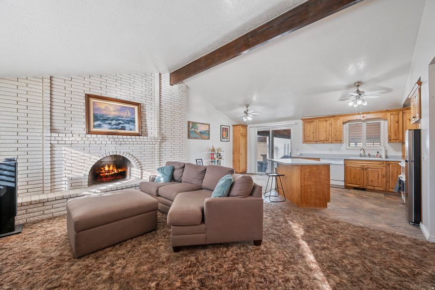 Welcome home to a rare find in this area...an ALL BRICK ABODE & mouth-watering oversized double garage and workshop w its own evaporative cooler! House boasts open-floor plan w a large great room on the main w newer kitchen w high-end all wood cabinetry, solid surface countertops and attached giant covered patio...perfect for entertaining!!! The property offers 3 bedrooms, 1+ bathrooms, and a ton of room to grow in the partially finished square footage in the lower level. Framing, electrical and some plumbing for additional family room, bedroom, bathroom and laundry/storage area make this property ripe for sweat equity! The low maintenance backyard w extra tall cinder block wall is xeriscaped, saving time for tinkering in the garage or relaxing on the patio with friends and family. With easy access to local amenities, schools, parks, and major highways, this home provides the perfect blend of comfort, and convenience. Don't miss your chance to see this incredible property-schedule your tour today! Information is deemed reliable, but not guaranteed, buyers verify all information and measurements.