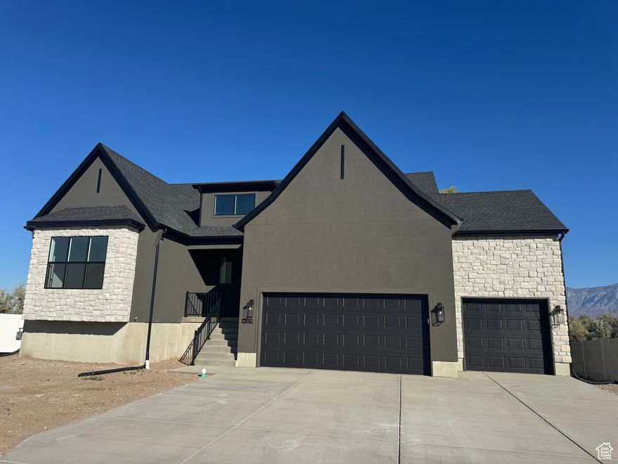 Seller is offering a preferred lender incentive, 7 year adjustable rate mortgage (7 year ARM) with rates as low as 4.875% for qualified buyers. Welcome to The Arches by Henry Walker Homes, a beautifully designed rambler in the heart of West Haven's best kept secret Cobble Creek Subdivision. This home offers effortless main-floor living, featuring 12-ft ceilings in the great room, a unique open staircase, and a bright, open layout. Enjoy quartz countertops, laminate flooring, a spacious kitchen, large pantry, and plenty of storage space. With 4 bedrooms, 3.5 baths, a partially finished daylight basement with a walkout, and a spacious 3-car garage, there's room for everything and everyone. Enjoy the best of West Haven-great schools, shopping, dining, and easy access to outdoor adventures. Experience luxury and convenience in The Arches-schedule your tour today! (Buyer to verify all information and square footage.)