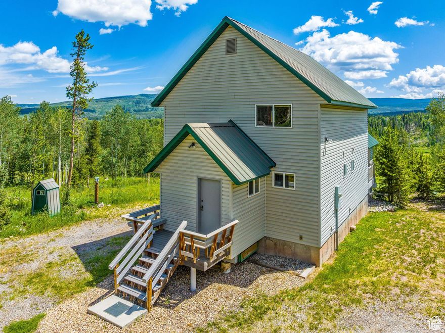 Welcome to your perfect year-round mountain escape. Tucked within the gated Uintalands community, this one-of-a-kind cabin offers the ideal blend of rustic charm and modern comfort. From the moment you step inside, you're greeted by soaring ceilings clad in floor-to-ceiling tongue-and-groove wood-sealed to perfection and radiating warmth. The main level features a spacious great room, a charming kitchen, and a cozy Primary Suite with its own en-suite bathroom. Upstairs, a lofted space overlooks the great room, giving you a front-row seat to everything from family game nights to quiet mornings by the fire. Step outside and let the fresh mountain air carry your worries away. Whether you're soaking in the views on the durable Trex deck or swapping stories around the fire pit, this secluded property is made for memory-making. Uintalands offers year-round access with a resident caretaker and a private pressurized water system that serves the entire cabin community-making both full-time living and weekend getaways seamless. Located just off Mirror Lake Highway and under 25 miles from Evanston, Wyoming. You'll also enjoy peace of mind and extra amenities nearby at the Bear River Ranger Station. Adventure awaits right outside your door with on-site hiking trails, a fishing pond, archery/shooting ranges, and picnic areas. No need for the fun to end when the snow flies! There are still plenty of options by hopping on your snow-cat or snowmobile. Fill up your day with by exploring hundreds of miles of pristine snowy trails. Uintalands even has dedicated parking for snowmobile trailers. This is more than a cabin, it's a lifestyle and one you will truly never want to leave.