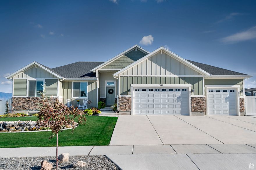 Built in 2023 and barely lived in, this nearly new home offers all the appeal of fresh construction with the rare advantage of being completely move-in ready. Set on nearly half an acre in one of Grantsville's newest communities, the home showcases contemporary design with an open main level that flows from the entry through the vaulted living room, framed by a wall of windows, into the kitchen and dining area. A main-level master suite completes the thoughtful layout.  The main-level master suite adds convenience, while the finished basement (all but one storage room) provides even more space to spread out.  Unlike nearby spec homes that still require tens of thousands of dollars in basement finishing and landscaping, this home is truly move-in ready. The fully landscaped yard features automatic sprinklers, a dedicated RV and truck parking pad with 30-amp outlet, double vinyl gates, and extra side access. Families with hobbies or animals will appreciate the fully fenced livestock/garden area with commercial-grade insulated shed, plus an additional 10'x20' storage shed with dual lofts.  The four-car garage is equally impressive: fully insulated, insulated bay doors, and heated, with 220v power, sink, and double-deep parking behind the third bay. Inside, upgrades include a high-efficiency fireplace insert with stone surround, premium mantle, and plantation shutters throughout the main level.  Here you'll enjoy a quiet rural setting just outside town, in a neighborhood where neighbors are close enough to connect but spread out enough to keep your peace. For buyers who want the appeal of new construction without the hassle or expense of finishing work and landscaping, this home is the rare turnkey solution-quality, convenience, and lifestyle from day one.