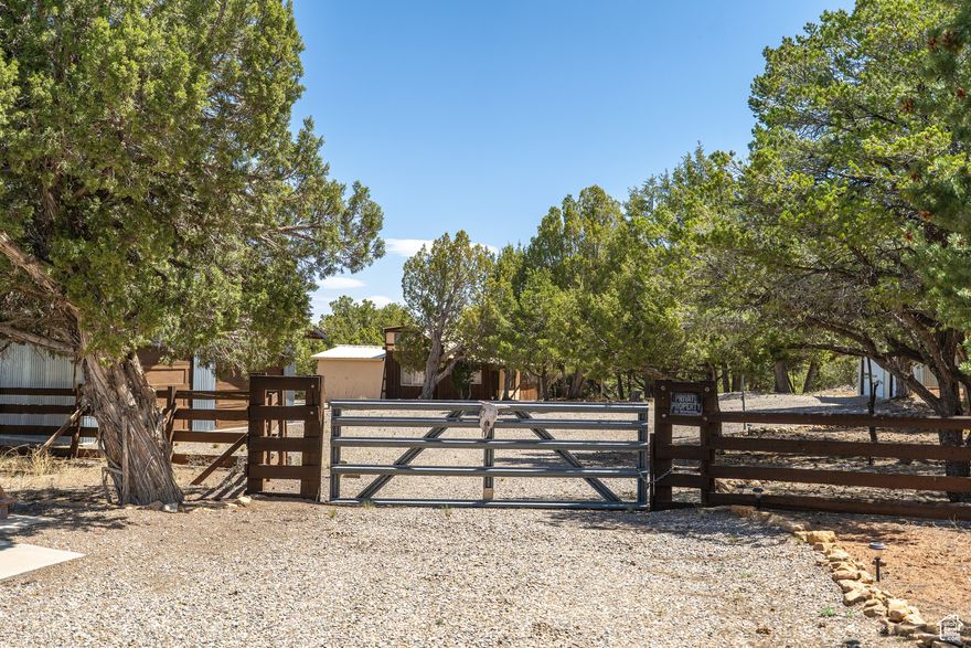 Escape to your private 20-acre sanctuary in Monticello! Imagine the serenity of juniper trees dotting your landscape, enhanced by thoughtfully laid gravel pathways leading to each of the three garages, original farmhouse structure, a carport, a cement pad, and mobile home on the property. The home features a good-sized master bedroom conveniently connected to a bathroom, and an abundance of windows fills the space with natural light. Enjoy a nice living room and a compact kitchen, complete with a washer and dryer, and sliding door. Discover the mature walnut tree adding character to the land. . You'll also find a substantial carport, perfect for additional covered parking or storage. The original farmhouse structure stands ready for its next chapter. Currently used for storage and filled with personal belongings (sold as-is), it holds the potential for remodeling, perhaps offering two bedrooms, one bathroom, and a loft, along with an existing freezer. There is a well with water right 09-553. This unique property offers space, potential, and the tranquility of the Monticello landscape. Condition of the property and all its contens are  unknown by current seller. Property is not eligible for traditionl financing.