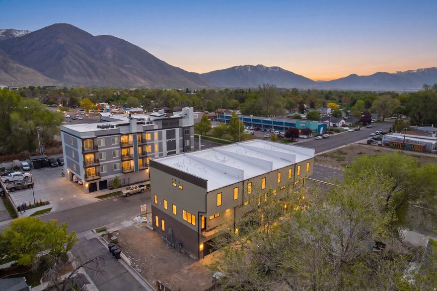 A new benchmark for Provo luxury living is rising just minutes from UVU and BYU. The Provo residential Brownstone Townhomes, scheduled for completion in 2026, bring a refined, Salt Lake City inspired aesthetic to one of Utah's most desirable real estate markets. This four residence collection pairs modern design with a rare lifestyle opportunity, thanks to a flexible lower level with its own street facing entrance. Each three-level townhome features four bedrooms, five bathrooms, and a two car garage. The lower level includes a full bedroom suite that can double as a workspace or family room creating high-value potential for creatives or investors seeking a rental friendly floor plan. The main level centers on a spacious great room with large windows, and an open kitchen and dining layout that mirrors the feel of upscale Salt Lake City and Utah luxury homes. A private deck expands the living area, and a half bathroom completes the level. Upstairs, the primary suite includes an ensuite bathroom and walk-in closet. Two additional bedrooms, each with its own ensuite bathroom, offer flexibility for family, guests, or income producing rentals. A dedicated laundry area is also on this level. With quick access to UVU, BYU, downtown Provo, I-15, and the broader Wasatch Front, the Brownstone Townhomes offer a strategic blend of convenience, design, and strong long term value. For buyers and investors seeking elevated new construction and the hallmark, this is one of Provo's standout opportunities.