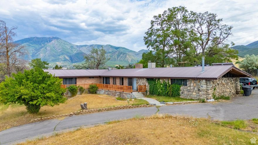 VIEWS ON 2 ACRES!  SELLER FINANCING AVAILABLE! Call agent for details. The possibilities here are endless-whether you're dreaming of the perfect retreat, planning to retire with stunning mountain views, Homestead with all the supplies to live off the grid or just need space for all your toys and projects, this property has it all. This beautifully maintained Rambler/Ranch home offers 4 bedrooms and 3 bathrooms with a spacious, well-thought-out layout. The large family room is perfect for gatherings, centered around a cozy fireplace and warm wood accents that make the space feel inviting and truly like home. The kitchen is both stylish and functional-ideal for everyday meals or entertaining. Two NEW furnaces keep the home comfortable year-round, and you'll also appreciate the recently replaced water heater and fully owned solar panels to help keep energy costs down. Big-ticket updates like a lifetime metal roof and a brand-new sewer and water line offer peace of mind for years to come. Wood burning fireplace and solar water heater make it possible to live off-grid. Step outside to take in the incredible valley views from the wraparound porch-perfect to start your day or winding down at sunset. With 2.06 acres, you've got the space to grow, add a garage, workshop, garden, or even explore possibilities of a business like assisted living, a group home. Whether you're looking for room to spread out now or planning for the future, this property offers the space, setting, and flexibility to make it yours. More than just a home-it's a lifestyle. Don't miss it!